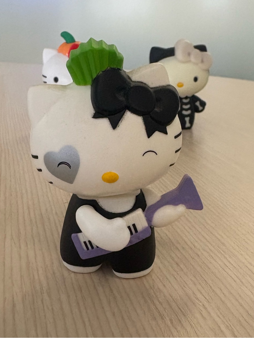 Hello Kitty Black & White Figurine with Purple Guitar and Green Accent